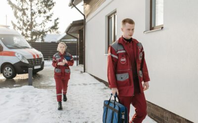 Medical professionals arriving at a snowy scene with emergency equipment.