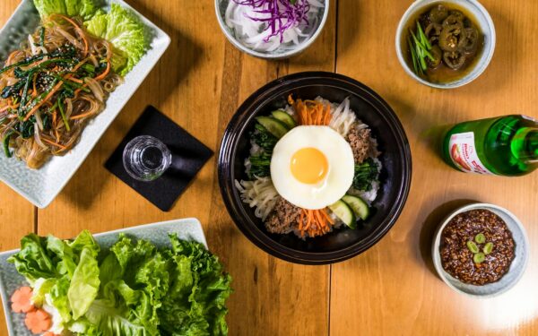 Delicious assortment of Korean dishes including bibimbap in a flatlay composition.