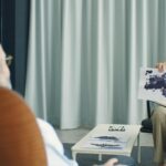 A therapist and patient in a psychotherapy session, discussing inkblot test results.