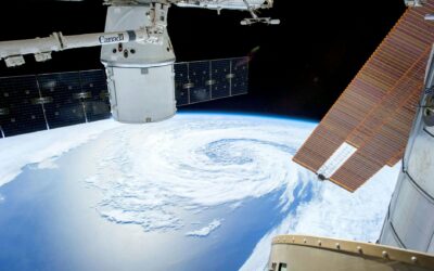 A mesmerizing view of Earth as seen from a space station with solar panels and satellite modules.