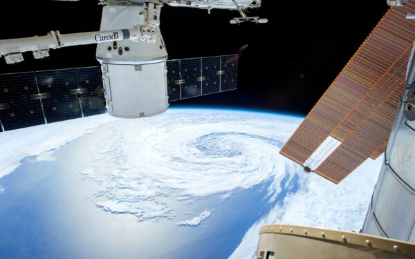 A mesmerizing view of Earth as seen from a space station with solar panels and satellite modules.