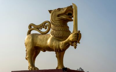 Golden lion statue symbolizing traditional art in Sri Lanka under clear skies.