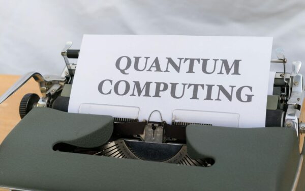 A vintage typewriter with a paper displaying the term Quantum Computing.
