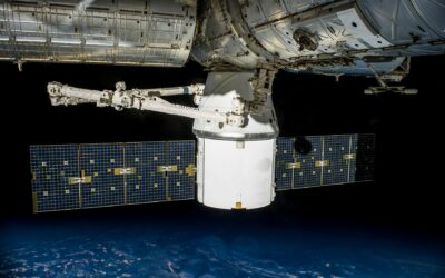 A satellite with solar panels orbiting Earth, capturing the vast universe.