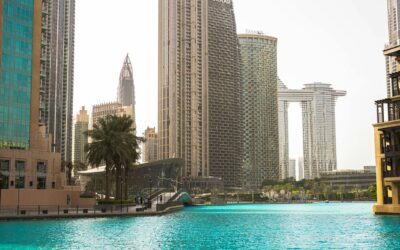 Stunning view of Dubai's modern skyline and vibrant blue water under a clear sky.