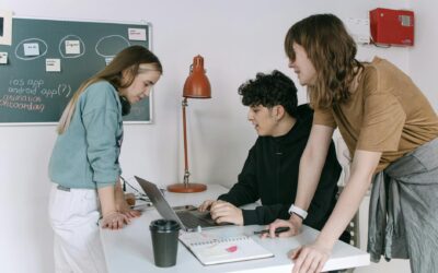 Group of young developers brainstorming ideas for a tech startup in a modern office setting.