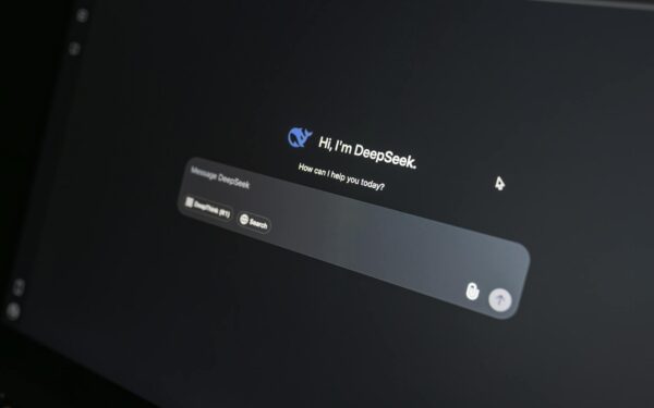 Close-up of DeepSeek AI chat interface on a laptop screen in low light.