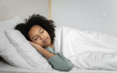 A serene scene of a woman with afro hair peacefully sleeping in a cozy bedroom.
