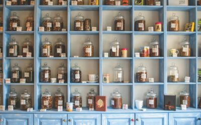 Organized display of herbal tea jars on vibrant blue shelves in a shop.