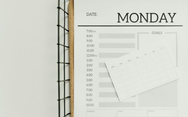 Top view of a minimalist schedule planner with Monday header. Perfect for organizing daily tasks with goals section.