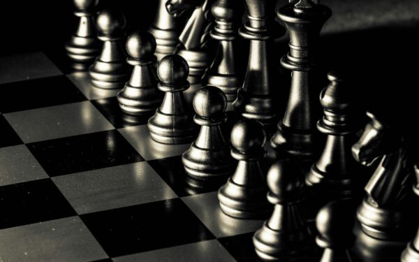 Close-up of a chessboard with pieces set for a strategic game, symbolizing intellect and planning.