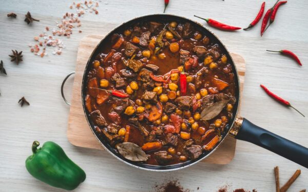 طرز تهیه خورشت بامیه مجلسی با رنگ قرمز تیره و بامیه‌های درسته